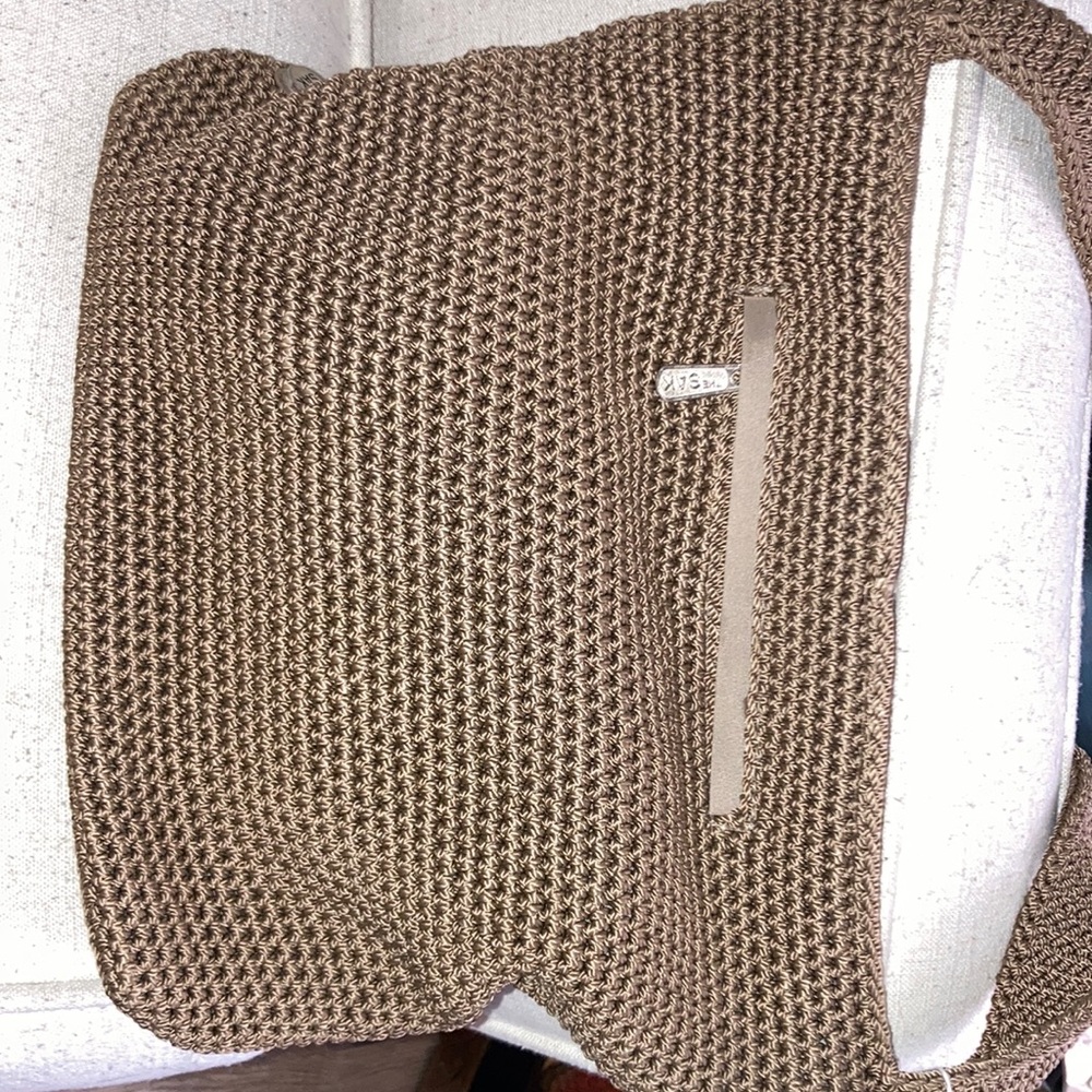 Tan, woven shoulder bag. The sak brand. Medium sized. Cute striped lining
